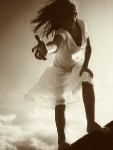 Woman reaching out a helping hand to help another as an act of karma yoga